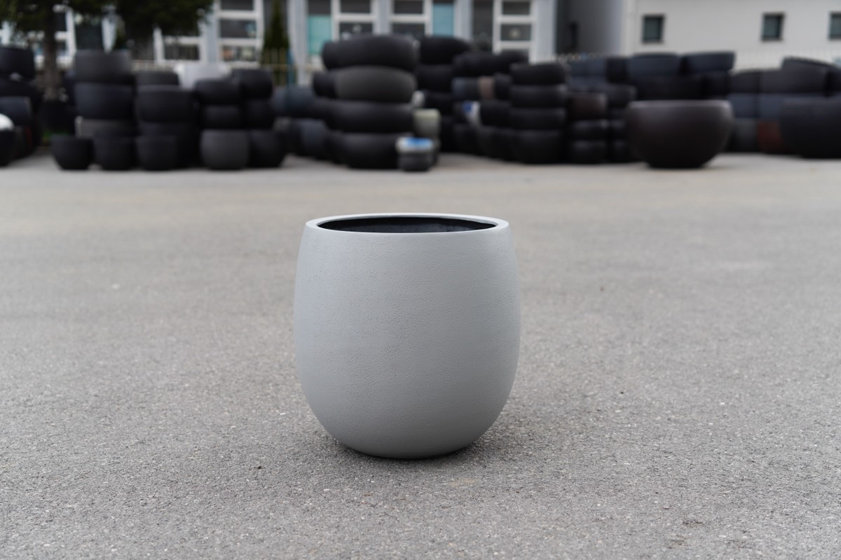 Smooth grey planter in the factory yard